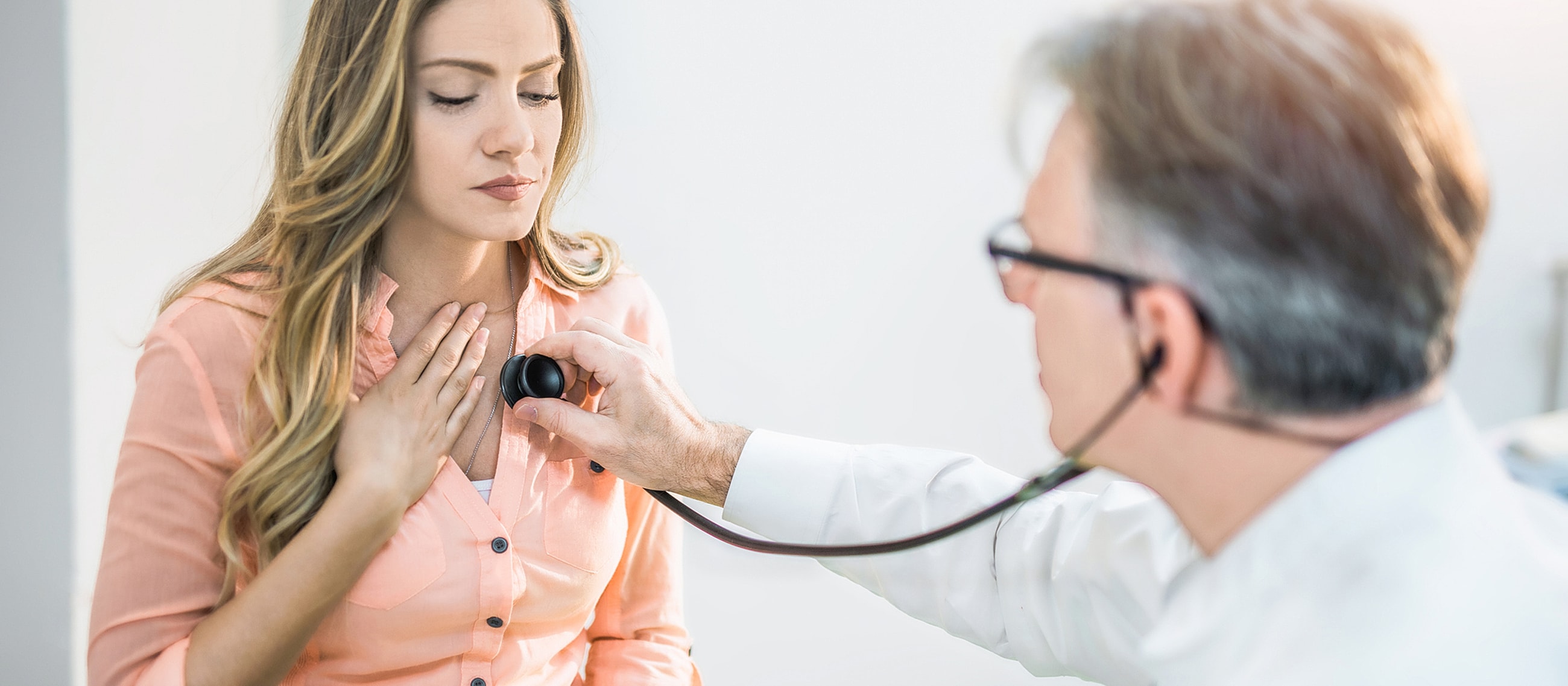 Doctor examining patient with a stethoscope.