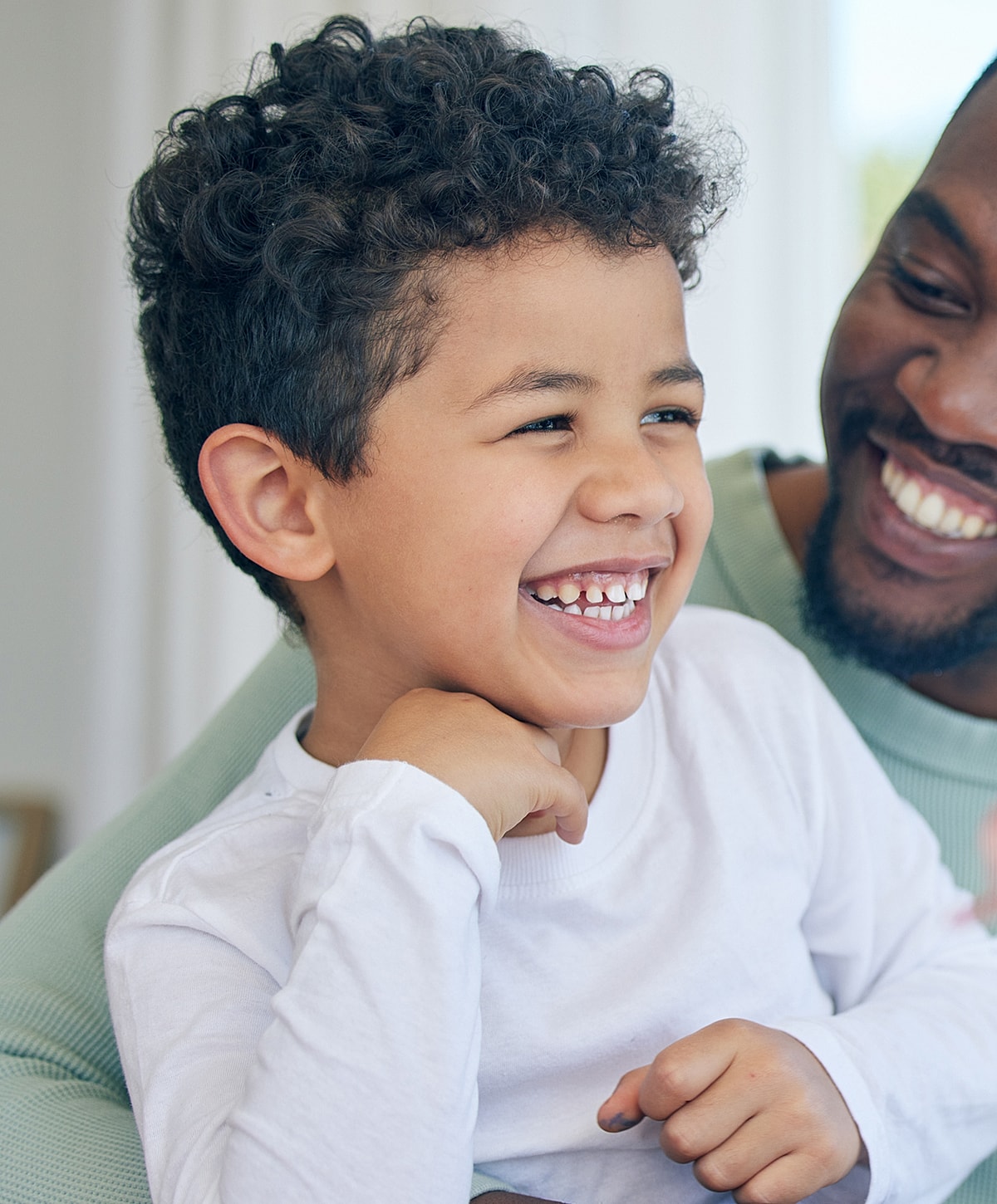 Smiling boy enjoying time with adult companion.