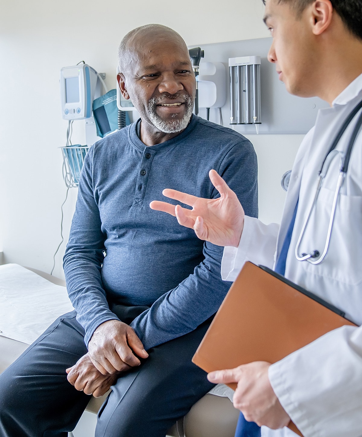 Patient discussing health with doctor in office.