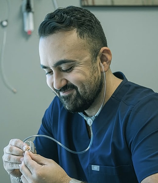 Smiling healthcare professional with stethoscope.