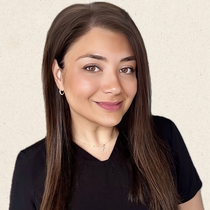 Smiling woman with long hair and black shirt.