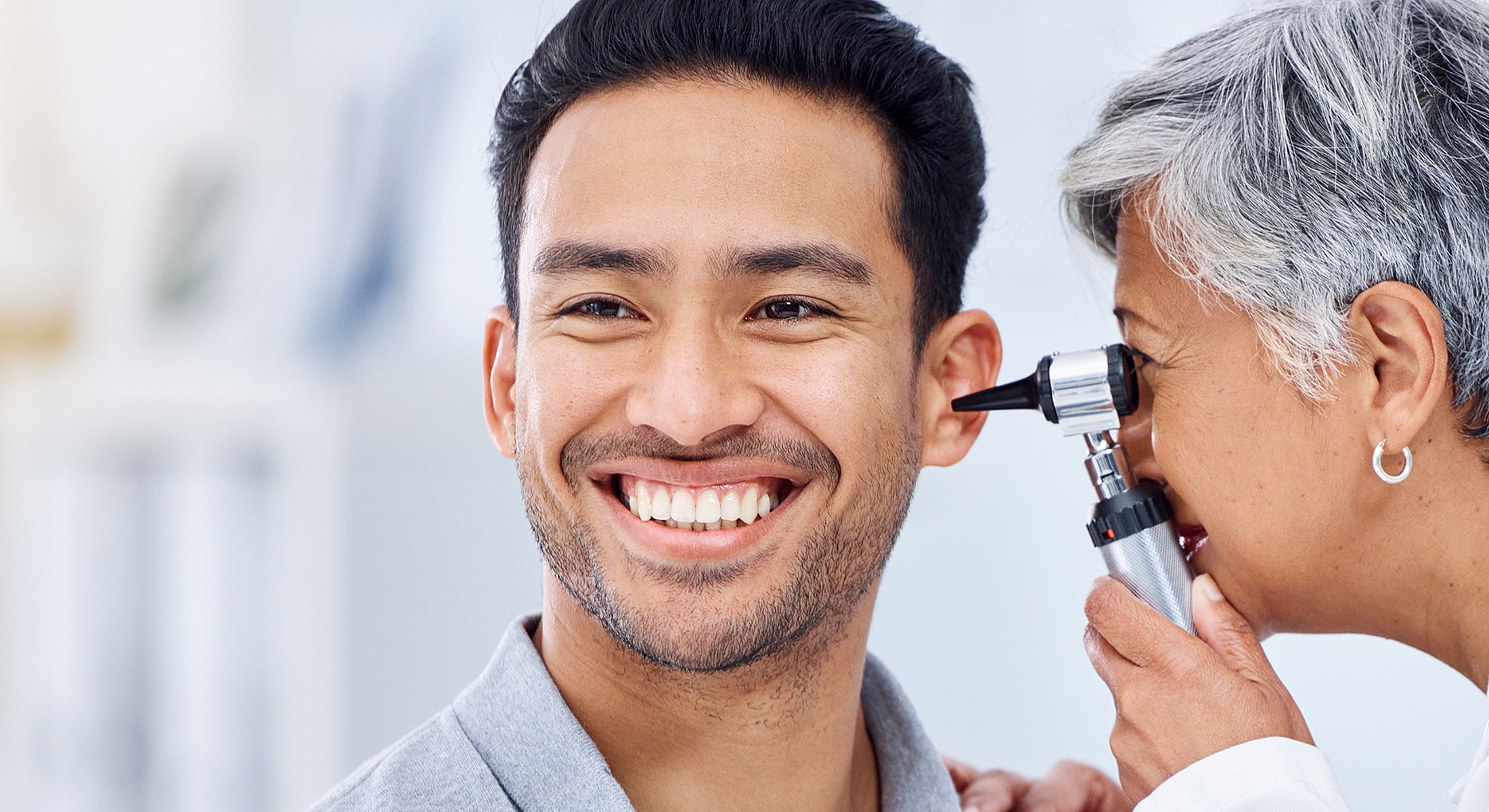 Medical check-up with smiling patient and doctor.