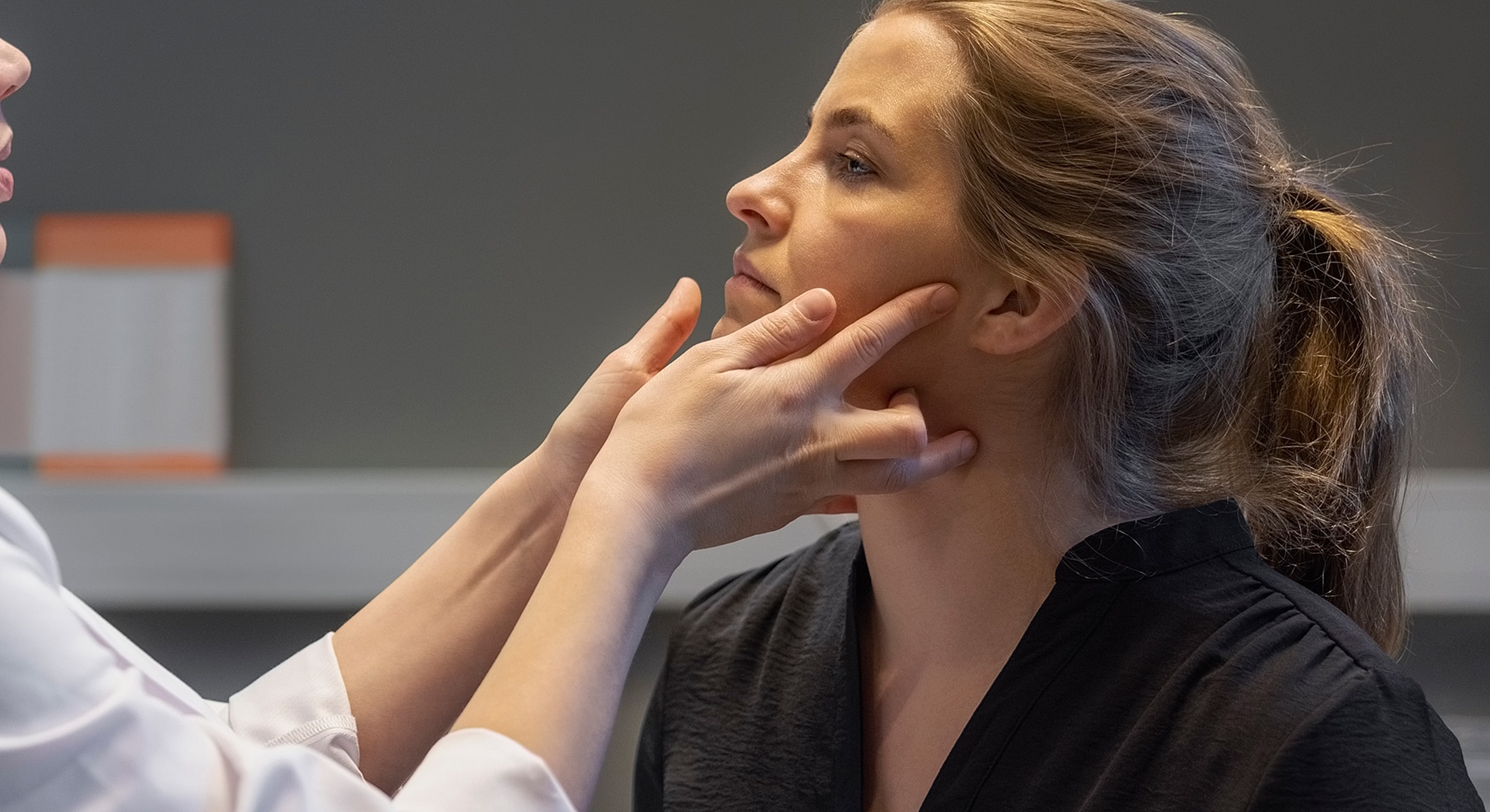Facial treatment session between two women.
