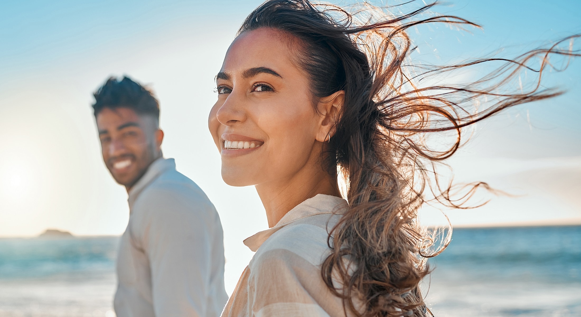 Couple enjoying a sunny day at the beach.