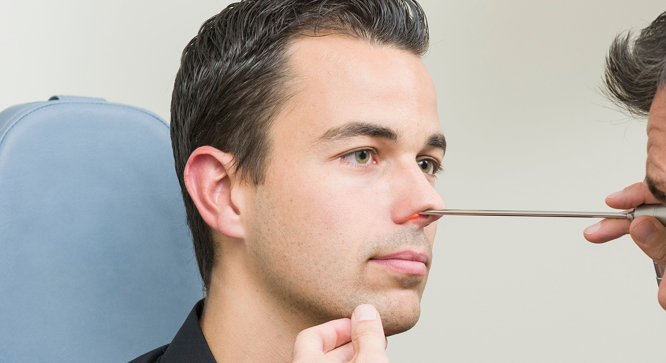 Medical examination of a man's nose.