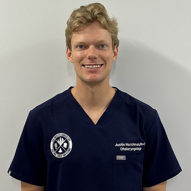 Smiling healthcare professional in medical scrubs.