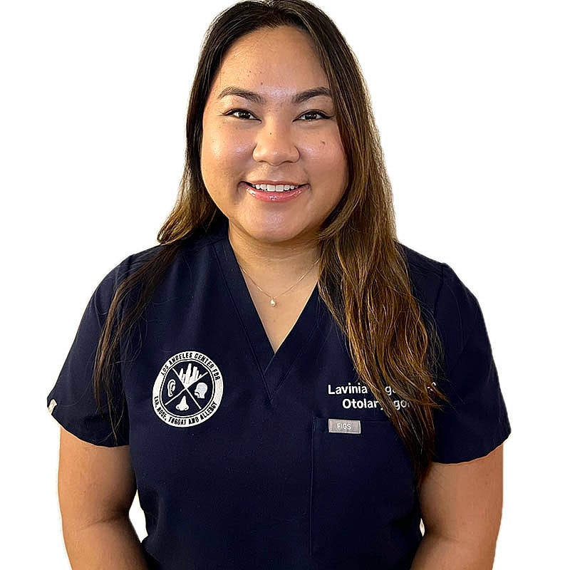 Smiling healthcare professional in navy scrubs.