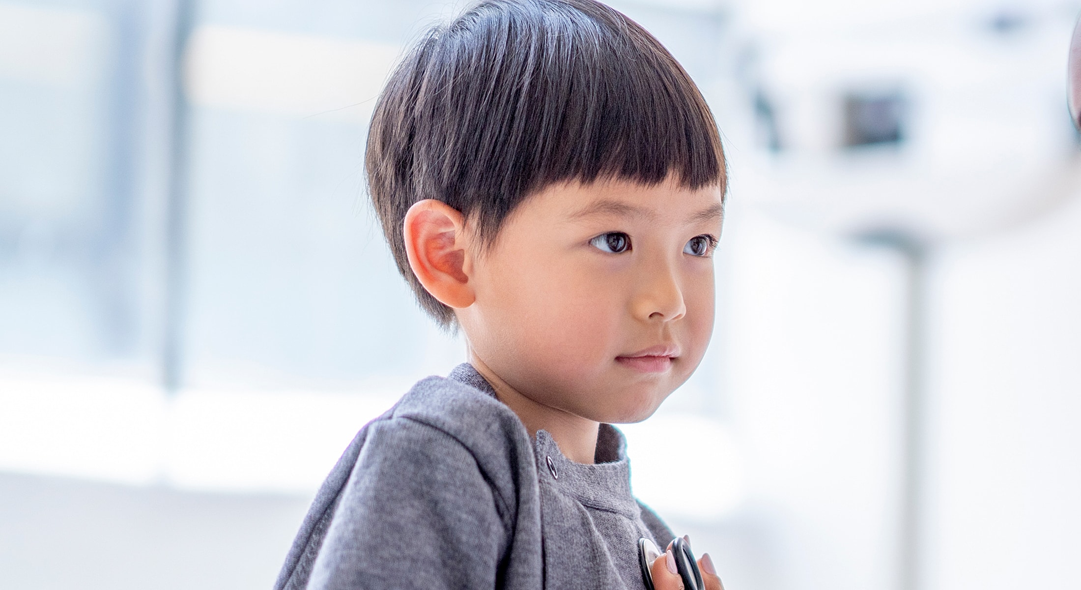 Young child looking thoughtfully to the side.