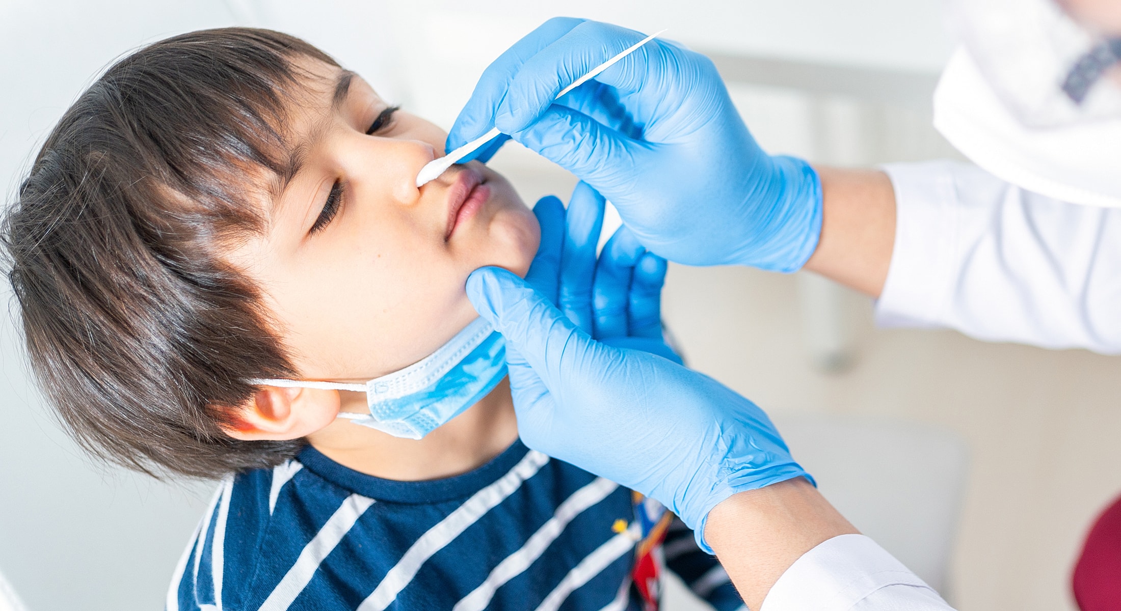 Child receiving a nasal swab test.
