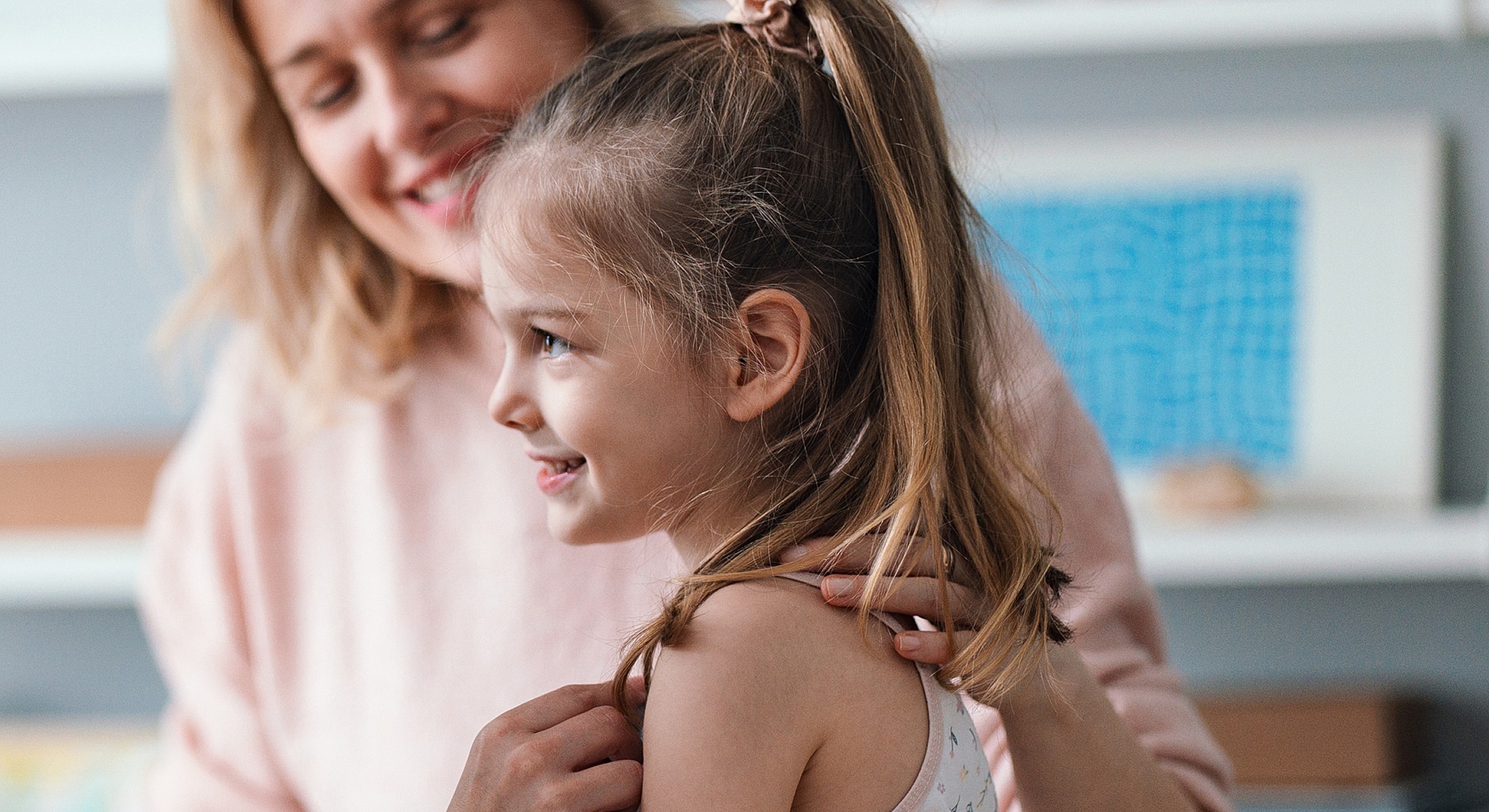 Doctor examining older woman's neck in clinic.