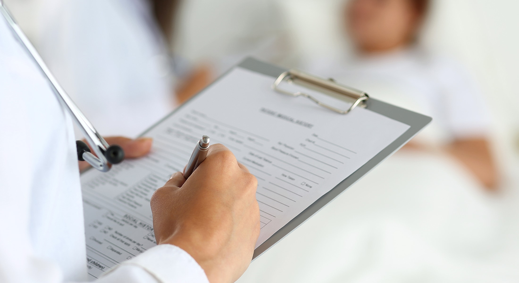 Doctor examining older woman's neck in clinic.