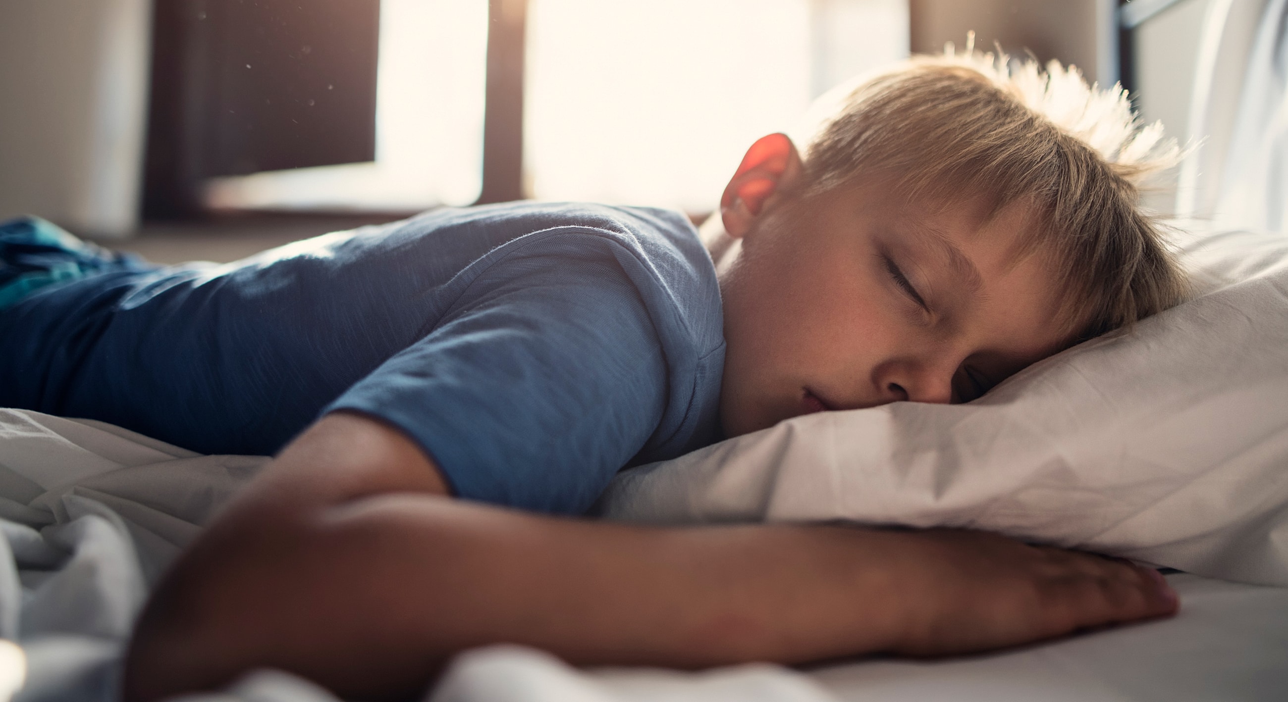 Child peacefully sleeping on a pillow.